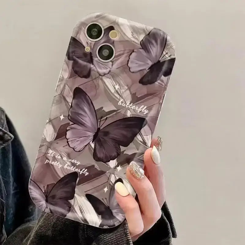 a woman holding a phone case with butterflies on it