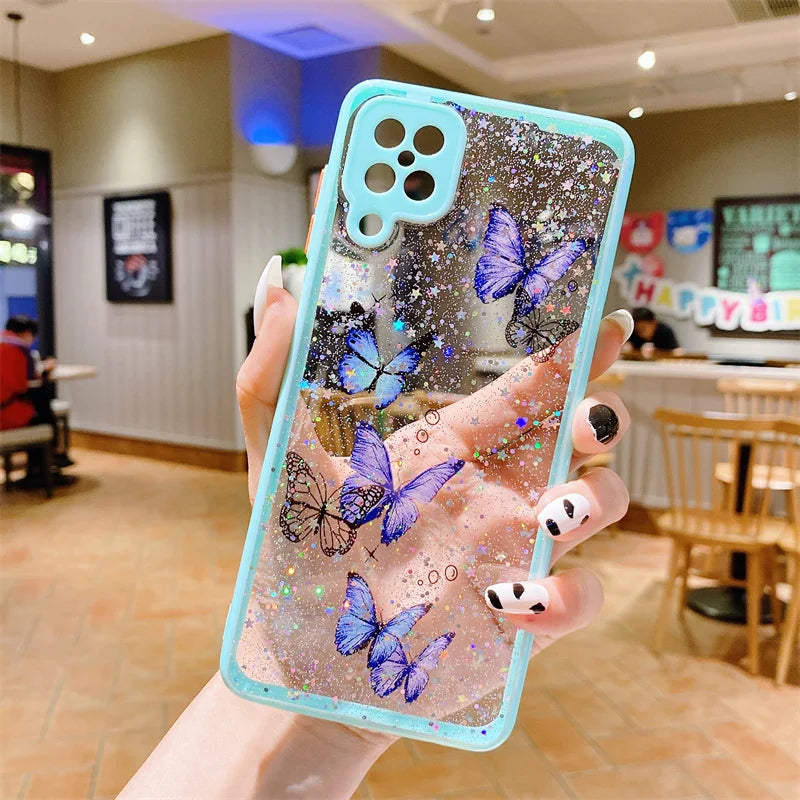 a woman holding up a phone case with butterflies on it