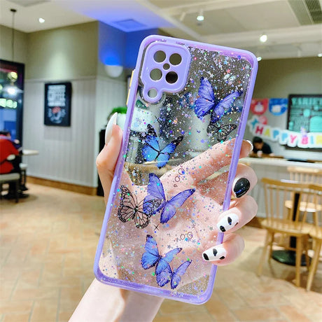 a woman holding up a phone case with butterflies on it