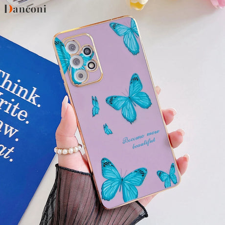 a woman holding a phone case with butterflies on it