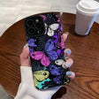 A woman holding a phone case with butterflies on it