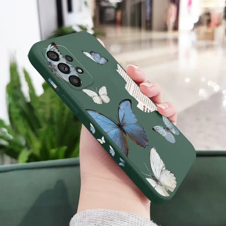 A woman holding a phone case with butterflies on it