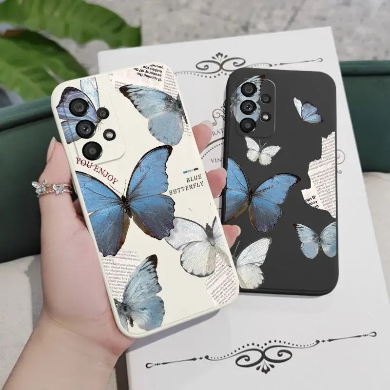 a woman holding a phone case with butterflies on it