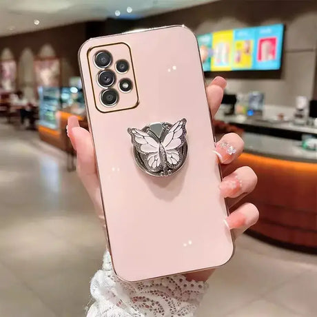 a woman holding a phone case with a butterfly on it