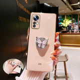 a woman holding up a phone case with a butterfly on it