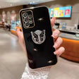 A woman holding up a phone case with a butterfly on it