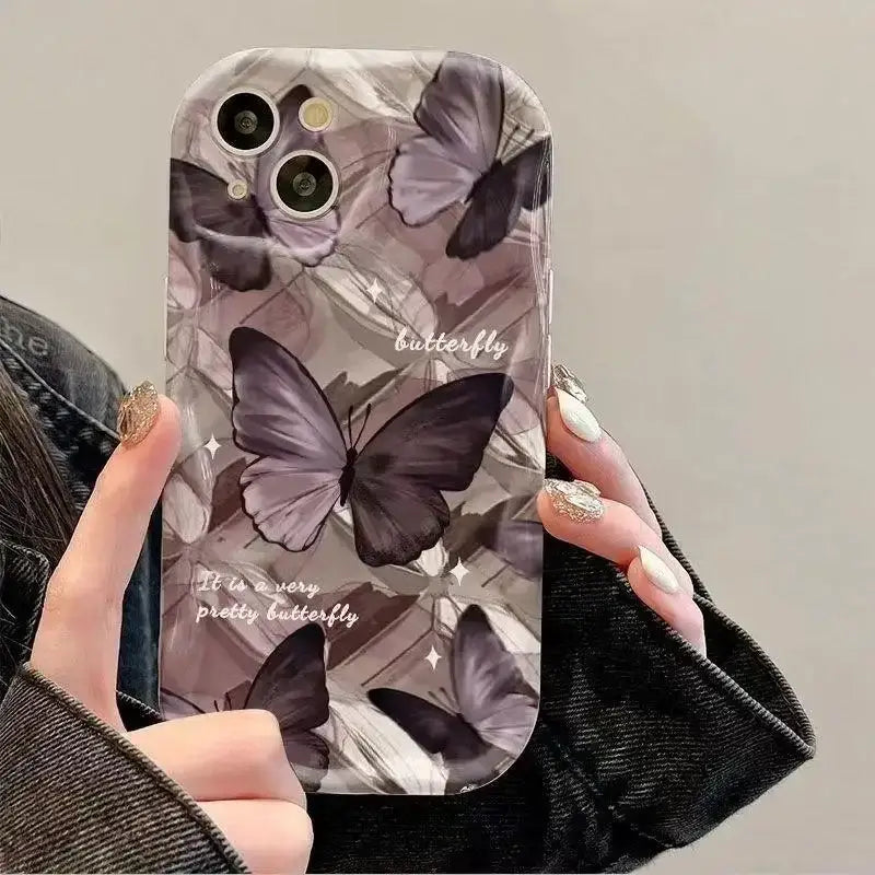 a woman holding a phone case with a butterfly pattern