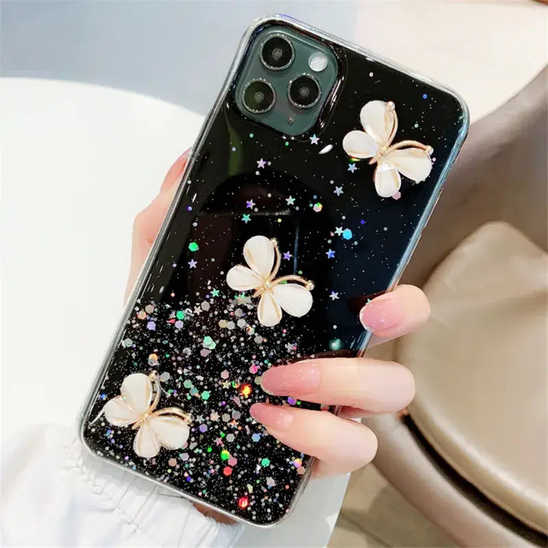 a woman holding a phone case with a butterfly on it