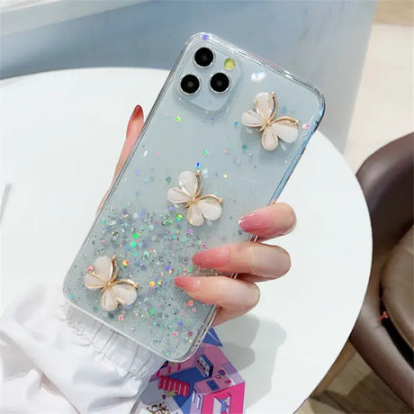 A woman holding a phone case with a butterfly design