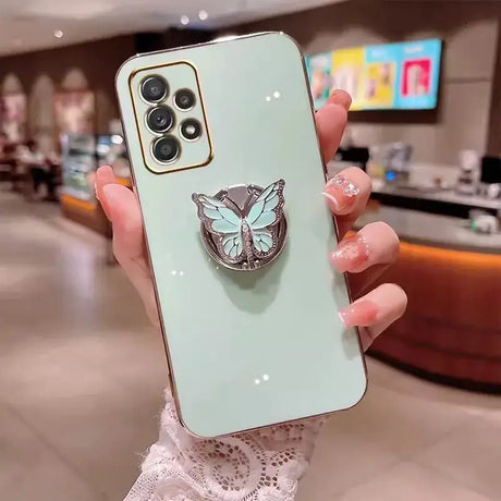 A woman holding a phone case with a butterfly on it