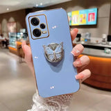 a woman holding a phone case with a butterfly on it