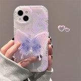 A woman holding a phone case with a butterfly design