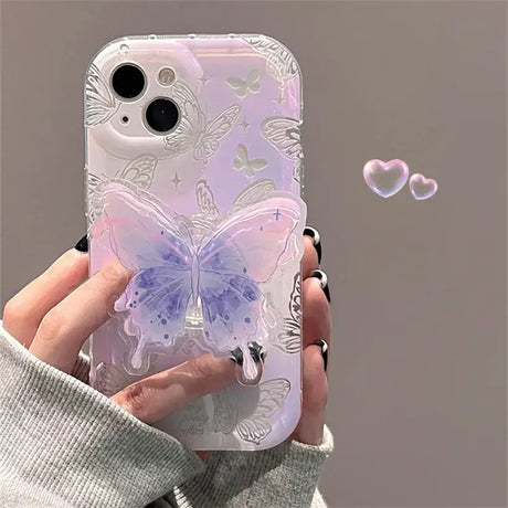 A woman holding a phone case with a butterfly design