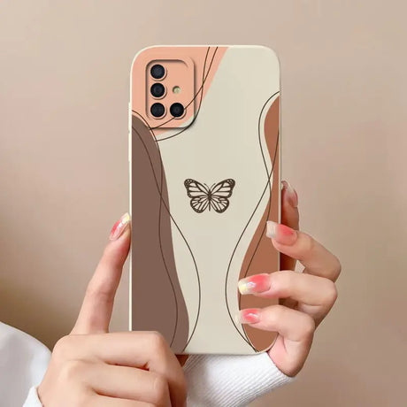 a woman holding a phone case with a butterfly on it