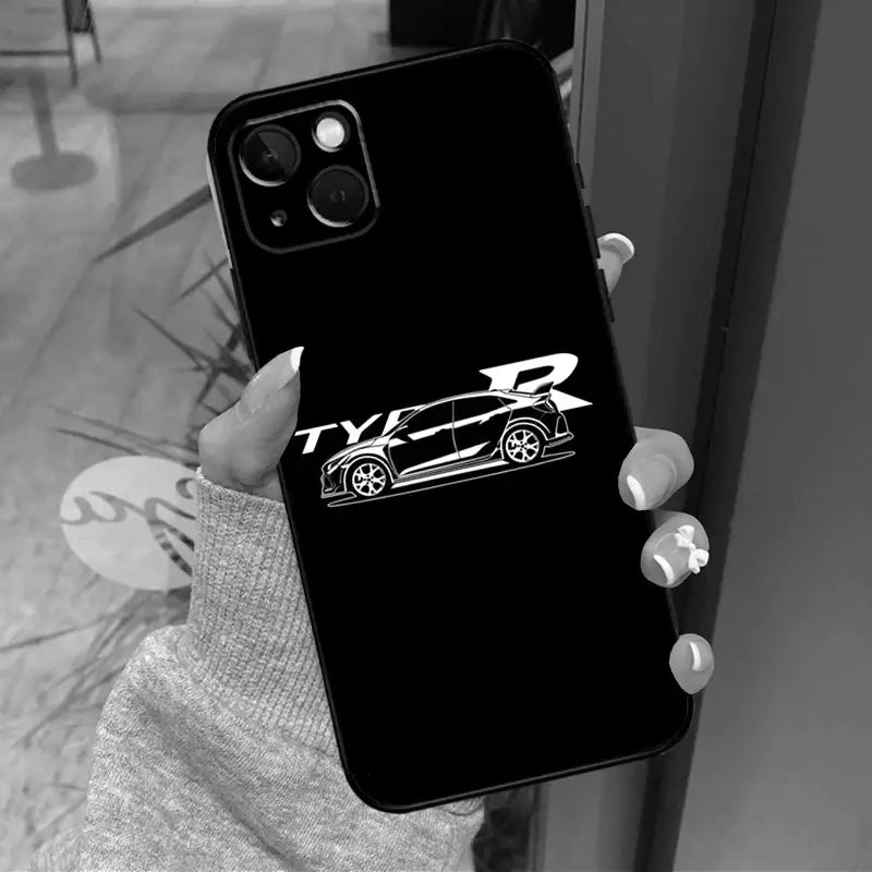 a woman holding a phone case with a car logo