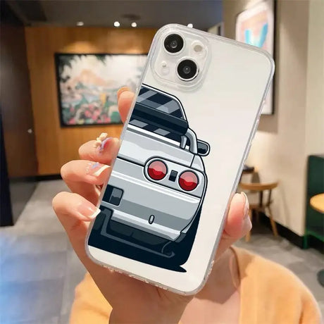 A woman holding a phone case with a car design