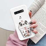a woman holding a phone case with a cartoon character