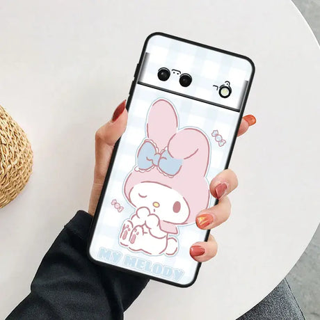 A woman holding a phone case with a cartoon character