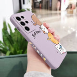 A woman holding a phone case with a cartoon cat on it