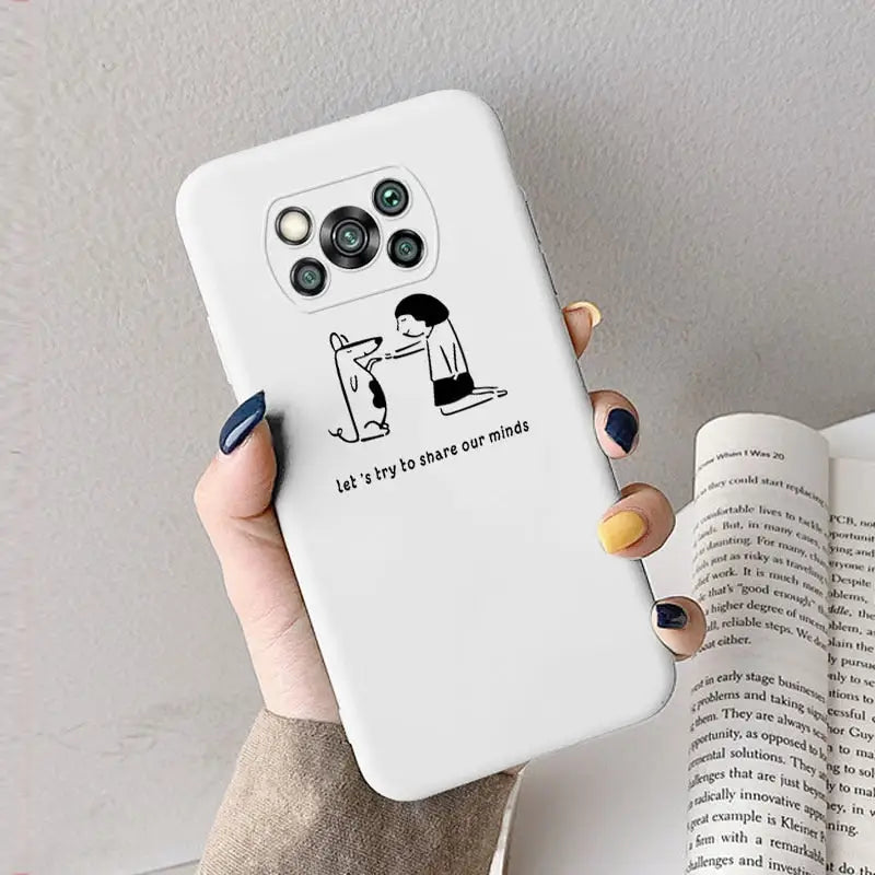 a woman holding a phone case with a cartoon drawing on it