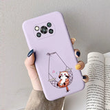 a woman holding a phone case with a cartoon cat on it