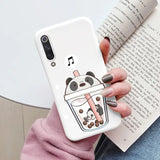 a woman holding a phone case with a cartoon character