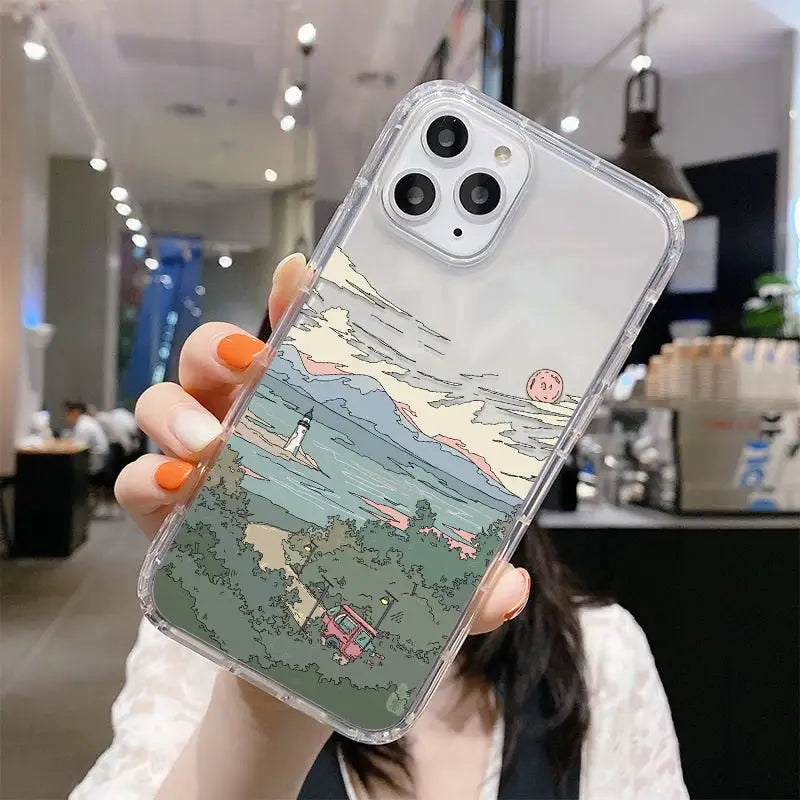 a woman holding up a phone case with a cartoon drawing on it