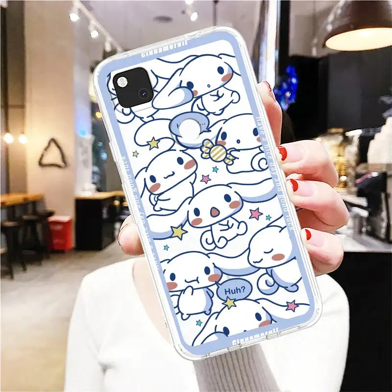 a woman holding up a phone case with a cartoon character design