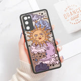 A woman holding a phone case with a cartoon sun and clouds