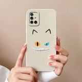 a woman holding a phone case with a cartoon face