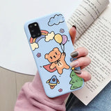 a woman holding a phone case with a cartoon character on it