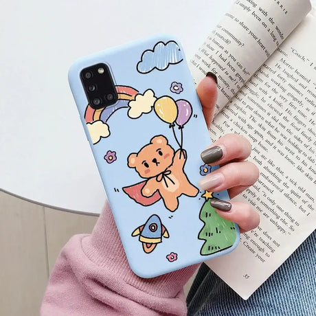 A woman holding a phone case with a cartoon character on it