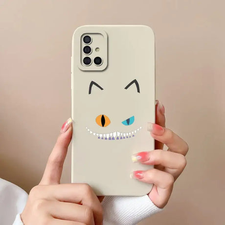 a woman holding a phone case with a cartoon face