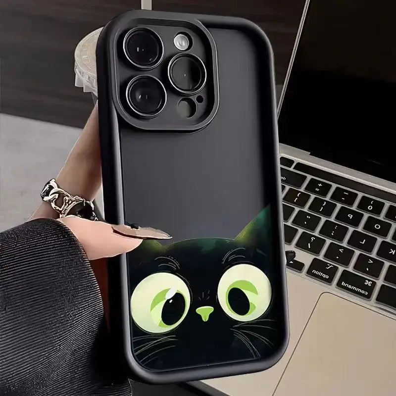 a woman holding a phone case with a cat face on it