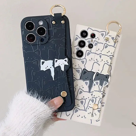 A woman holding a phone case with a cat design