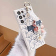 A woman holding a phone case with a cat pattern