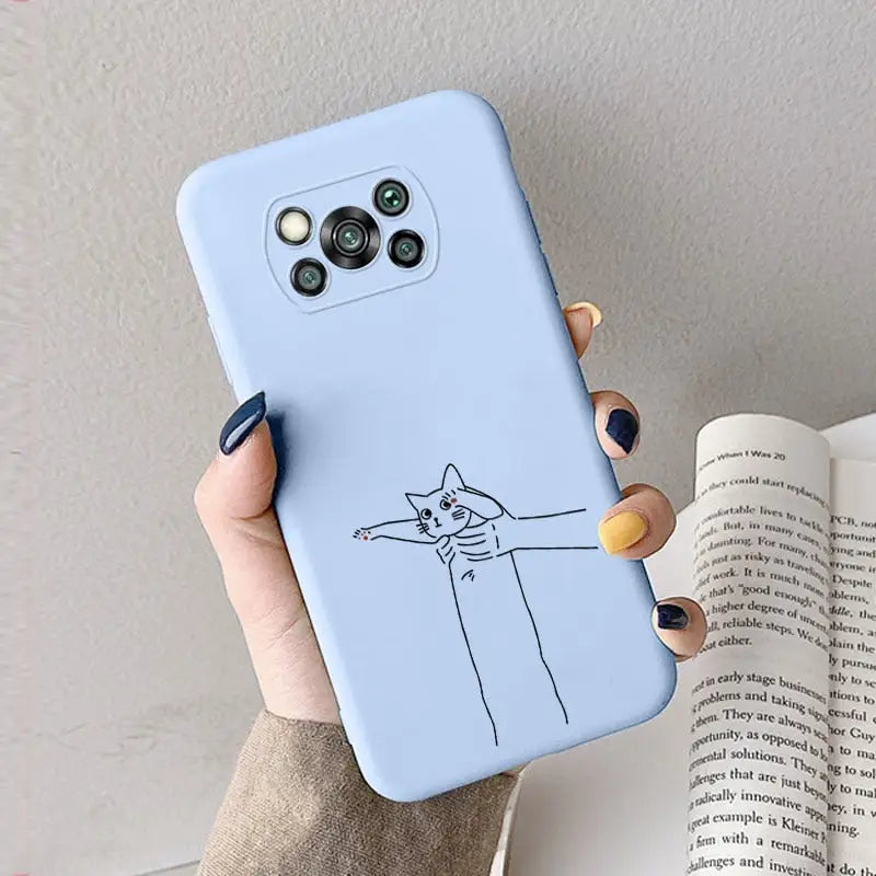 a woman holding a phone case with a cat drawing on it