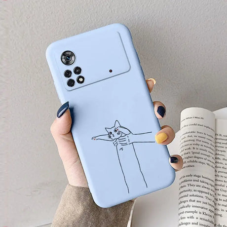 A woman holding a phone case with a cat drawing on it