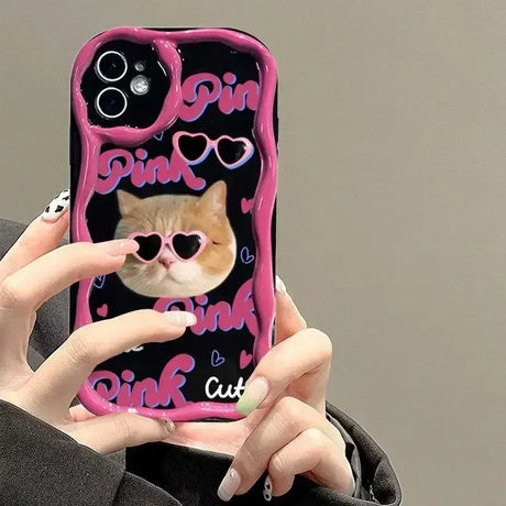 A woman holding a phone case with a cat on it