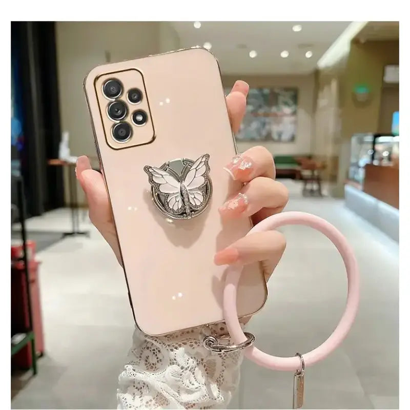 a woman holding a phone case with a cat head on it