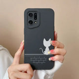 a woman holding a phone case with a cat on it