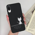 a woman holding a phone case with a cat on it