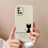 a woman holding a phone case with a cat on it