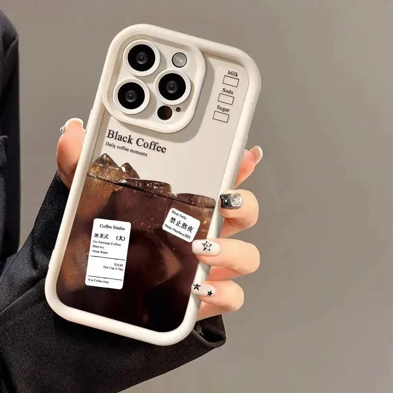a woman holding a phone case with a coffee in it