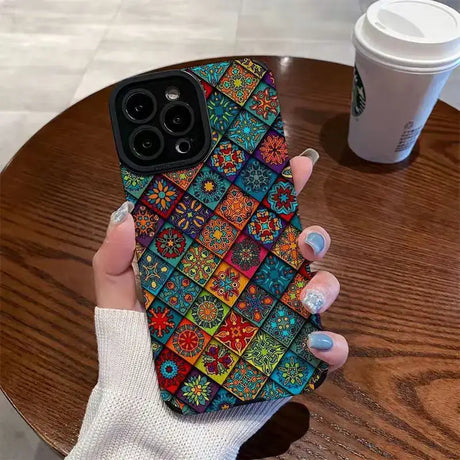 A woman holding a phone case with colorful flowers on it