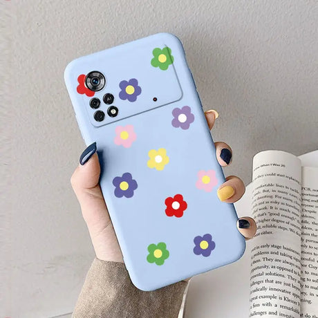 A woman holding a phone case with colorful flowers on it