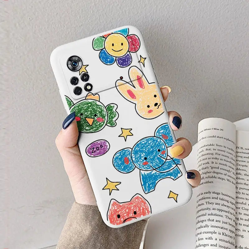 a woman holding a phone case with colorful fish and fish drawings on it