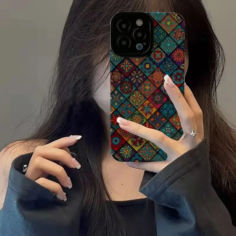 A woman holding up her phone case