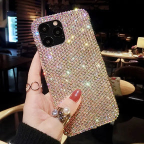 a woman holding up a phone case with a diamond design