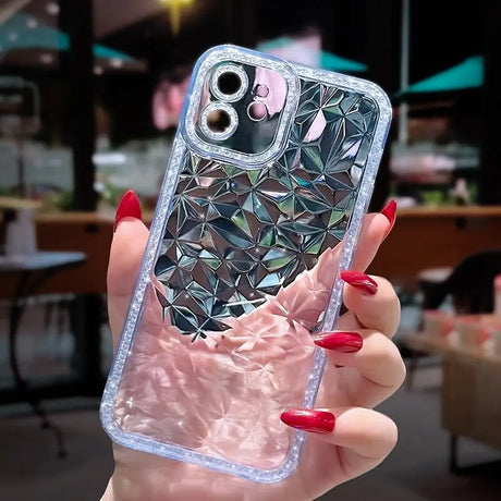 A woman holding a phone case with a diamond pattern